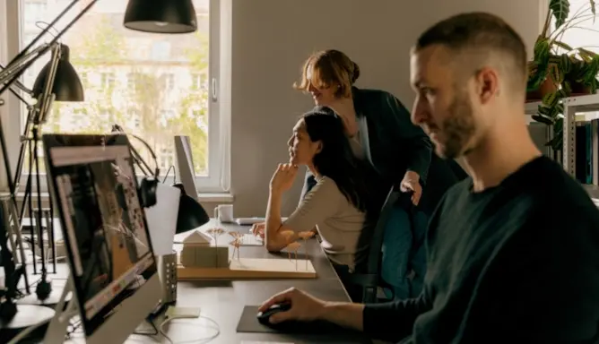 Two people talking together at a modern office, like Typeform's.